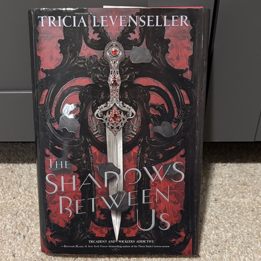 The Shadows Between Us Hardcover Book